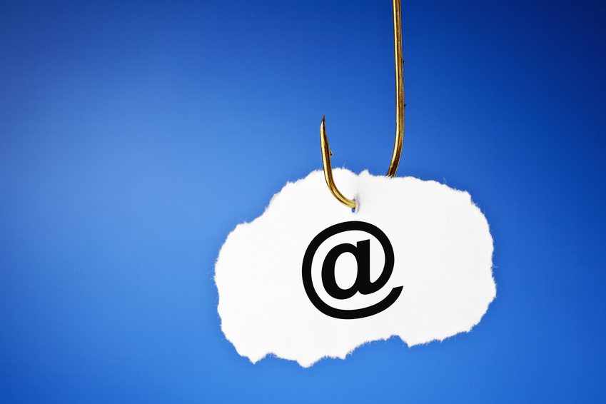 E-mail symbol printed on a piece of paper hooked on a fishing hook. Phishing and data protection concept.